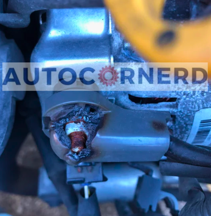 Alternator electrical connection with visible discoloration around the terminal.