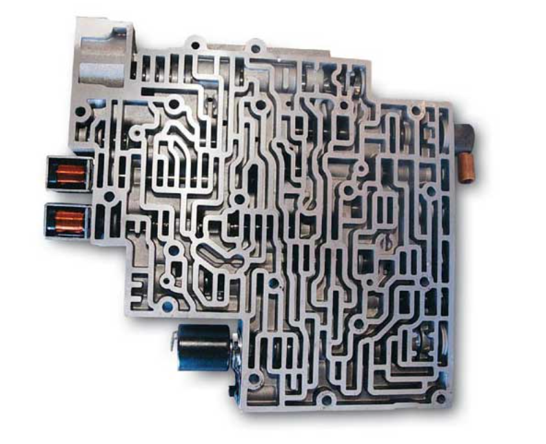 Automatic-transmission valve body showing its fluid passages and attached solenoids.