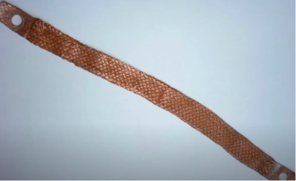 Braided copper ground strap with a mounting eye at each end.