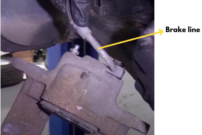 Brake line identified beside a brake caliper.