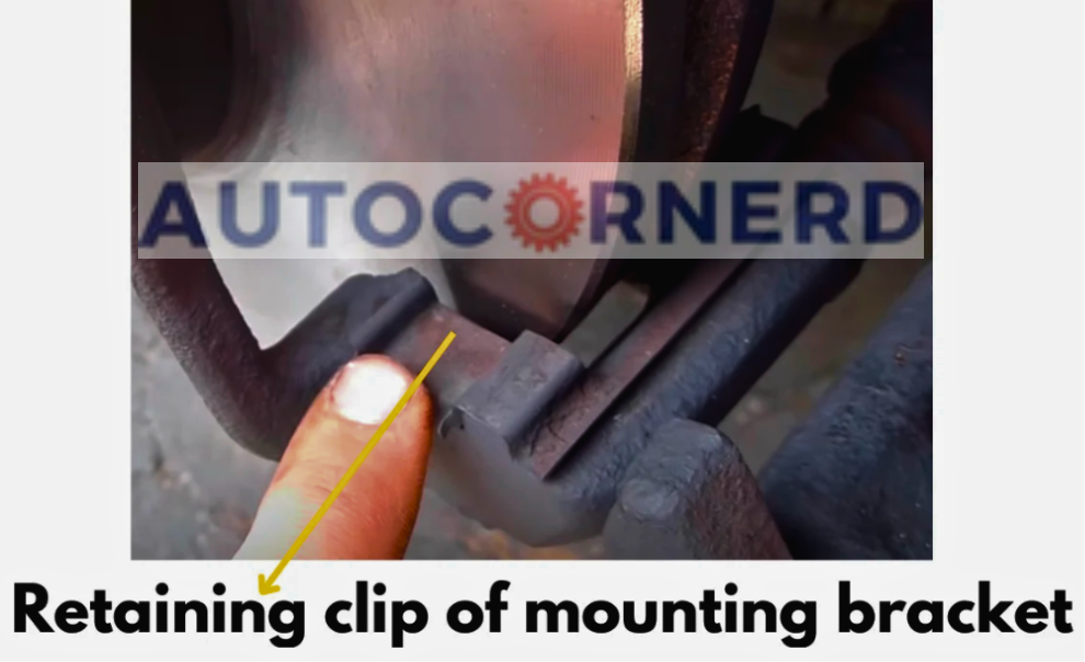 Brake-pad retaining clip identified beside its mounting bracket.