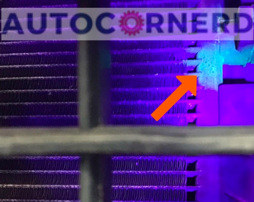 Fluorescent inspection mark near a condenser connection under ultraviolet light.