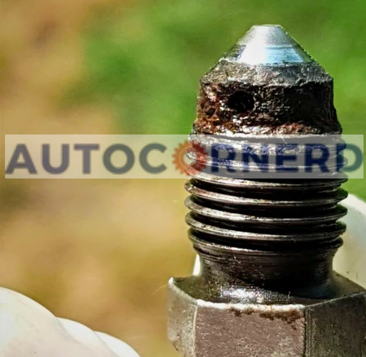 Threaded metal fitting with a corroded and damaged upper end.