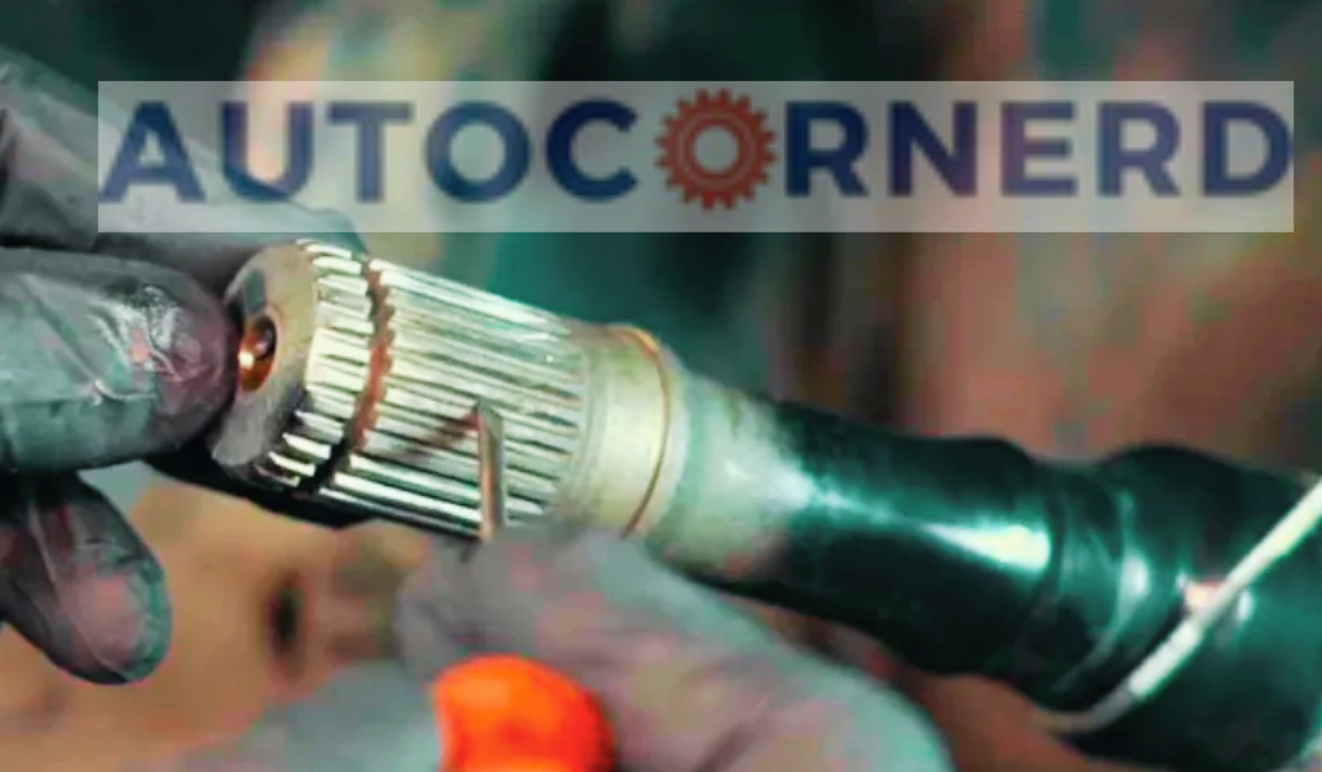 Splined end of a CV axle shaft held for inspection.