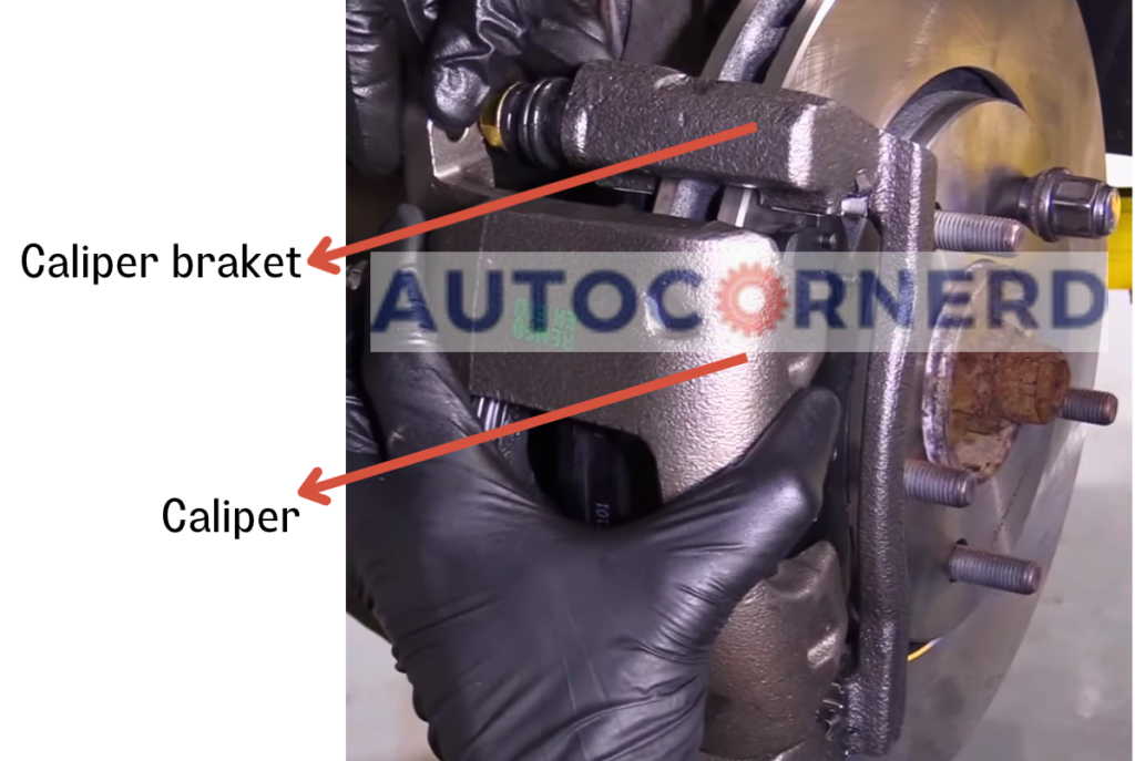 Disc-brake photo identifying the caliper and its mounting bracket.