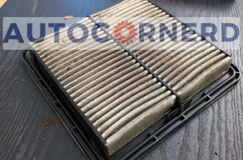 Pleated engine air filter with accumulated dirt and debris.