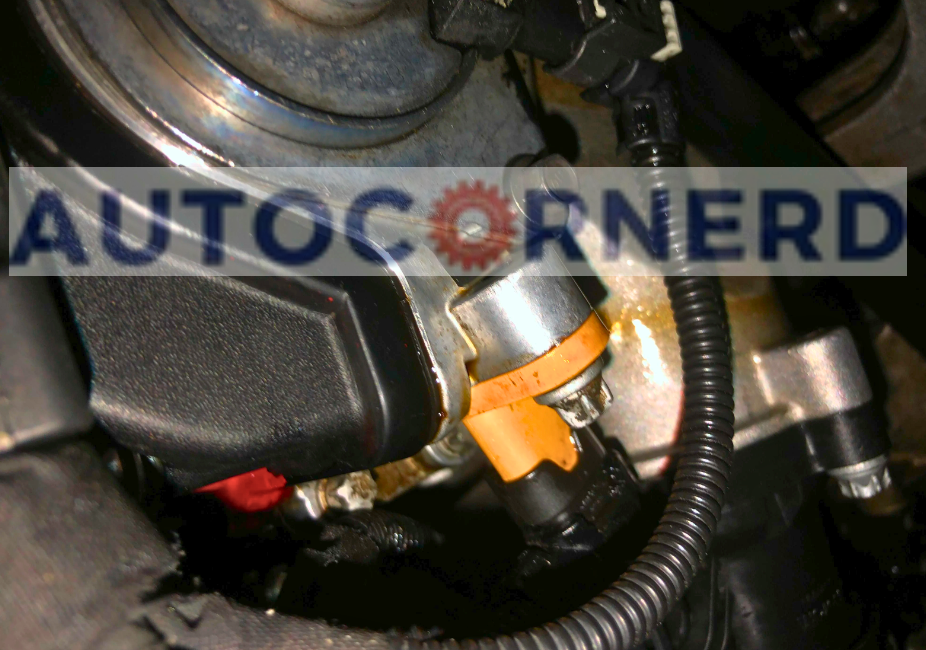 Sensor connector and mounting area beside an engine housing.