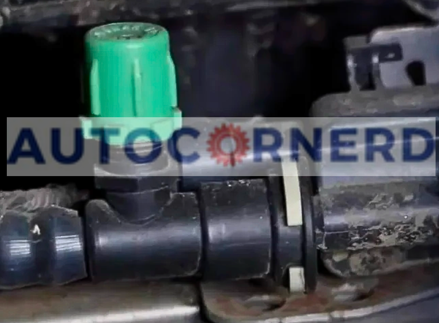 Vapor-line component with a green cap and connected hoses.