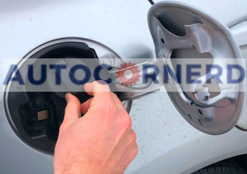 Hand holding a gas cap beside an open fuel door.