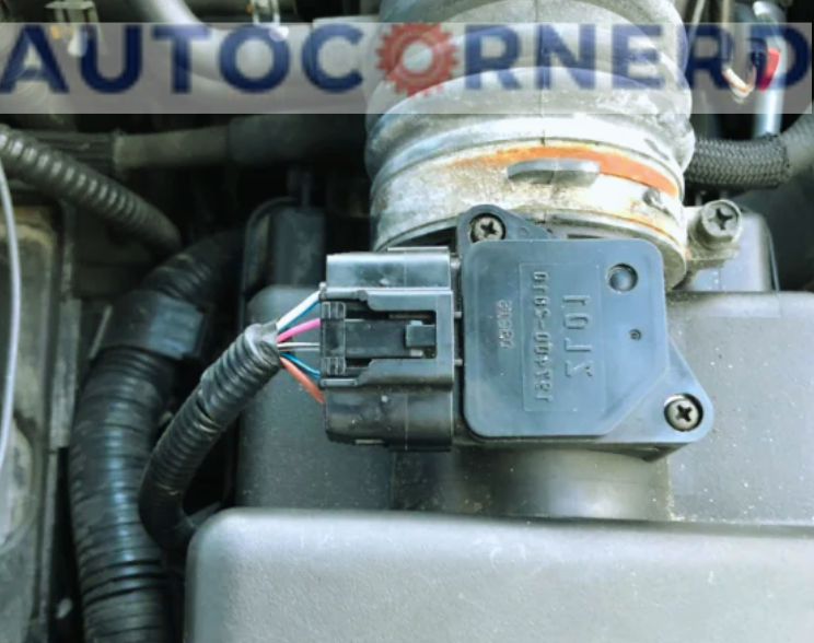 MAF sensor and electrical connector attached to intake tubing.