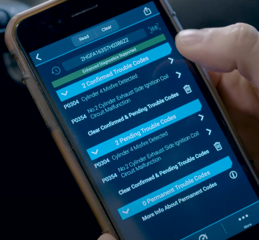 Phone displaying an OBD diagnostic application and trouble-code categories.