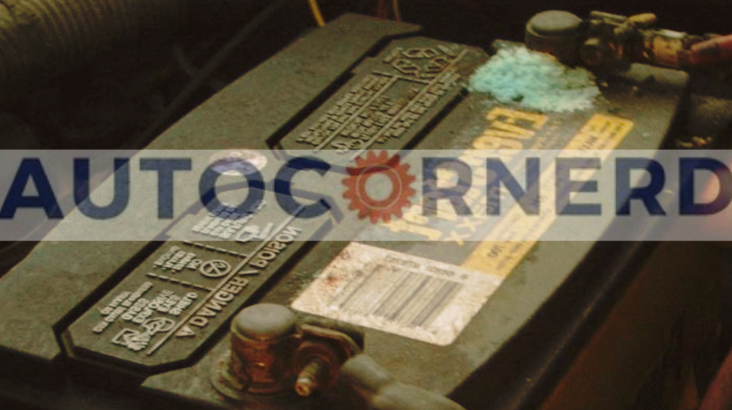 Vehicle battery with corrosion deposits around its terminal connections.