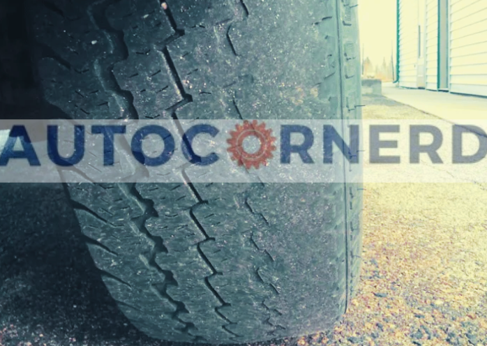 Vehicle tire showing uneven wear across its tread.