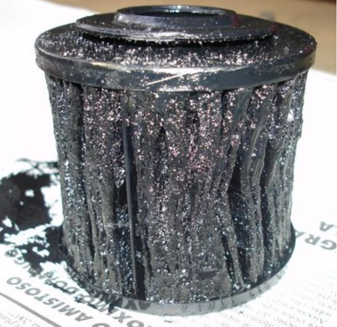 This oil filter's severe blockage could be the culprit behind insufficient oil pressure at idle, emphasizing the importance of regular oil maintenance.