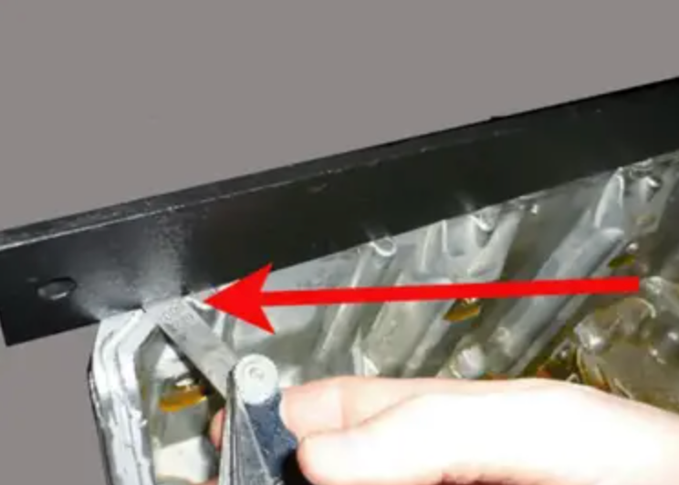 using straight edge to check flatness of mating surface of the oil pan