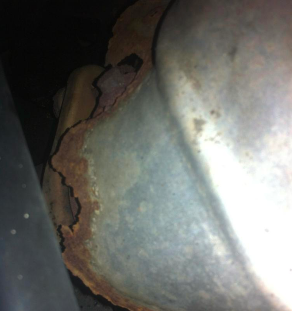 rusted heat shield around exhaust