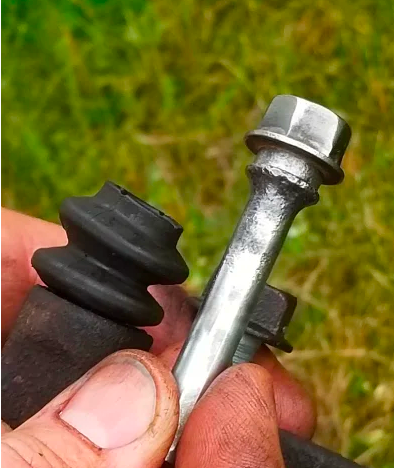 applying lubricant on caliper slider pin