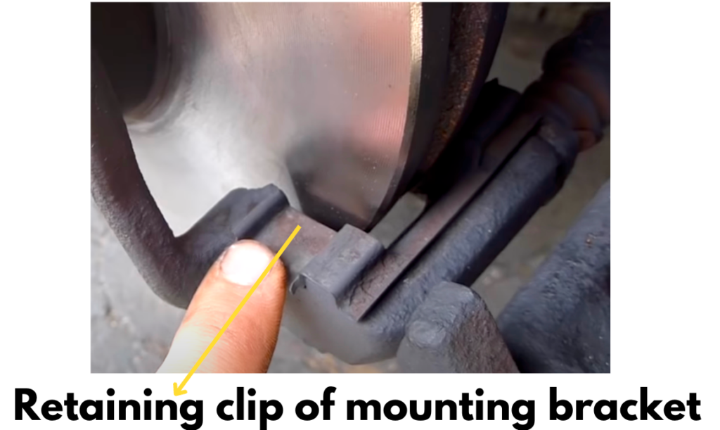 Retaining clip of brake caliper bracket where brake pads fit