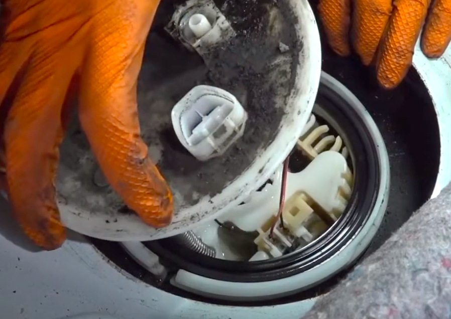 removing fuel pump assembly at slight angle to prevent damage of fuel level float arm