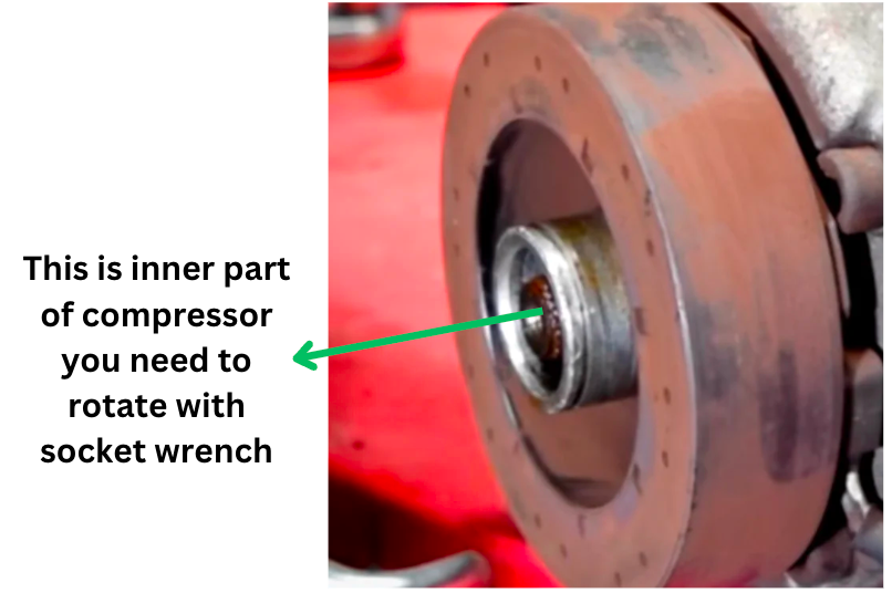 testing car ac compressor by rotating inner part with socket wrench