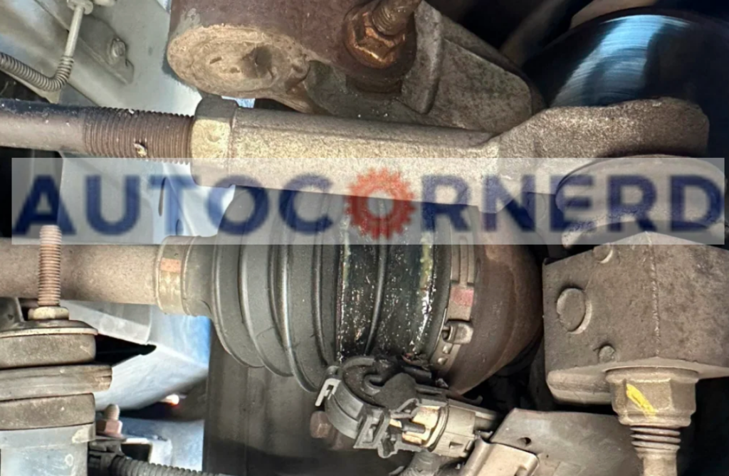 A close-up view of a vehicle’s undercarriage, showing the failing CV joints that are causing a popping sound. The CV joints are visibly worn and covered in grime, indicative of significant use and potential failure. Rust and corrosion are evident on the surrounding metal parts, suggesting that maintenance has been neglected